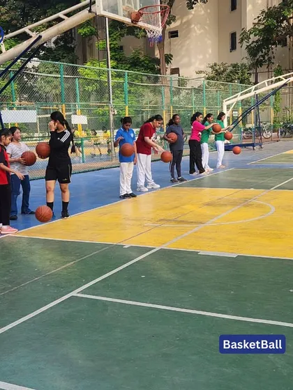 A group of girls lines up for a basketball drill. Our camps are inclusive and provide opportunities for all players to develop their skills and confidence.