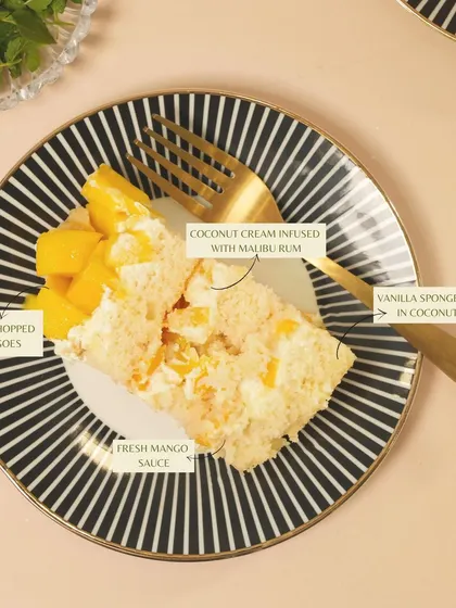 A detailed look at my Mango Coconut cake, featuring vanilla sponge soaked in coconut milk, fresh mangoes, and a coconut cream infused with Malibu rum.