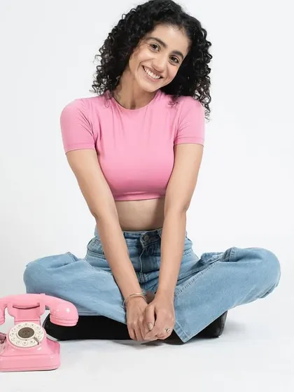 A fun monochrome look, where the pink top is paired with subtle pink tones in the makeup. I kept the model's natural curly hair to complete the look.