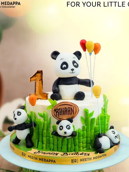 A playful party of pandas for Rihaan's first birthday. This cake is decorated with bamboo-style fondant and several cute, handcrafted pandas.