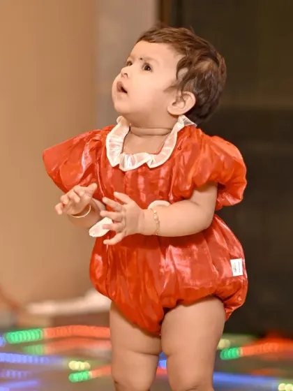 A candid shot of the birthday girl looking up in wonder during her party. Capturing these spontaneous moments of awe is a key part of my event photography style.