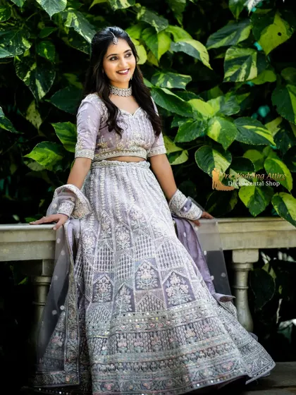 The lavender lehenga shown in a relaxed, seated pose, highlighting the comfortable fit and beautiful drape of the fabric.
