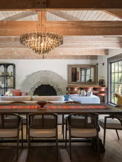 Another view of the chandelier installation in the Saratoga home. This shot shows the scale of the light fixture in relation to the high, beamed ceiling and the open-plan living space.