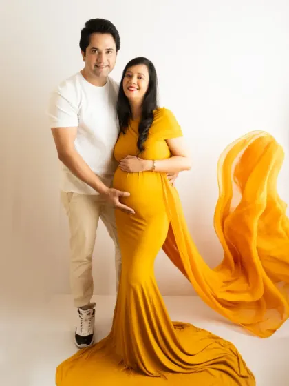 A beautiful standing portrait of a couple, with the flowing yellow gown adding a pop of color and elegance.
