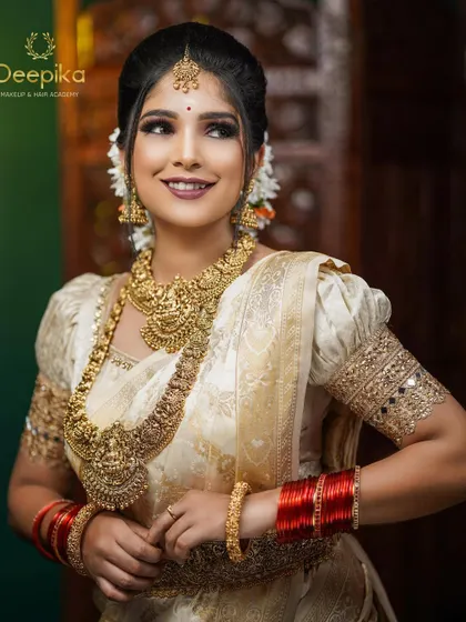For this Onam look, I designed a classic cream blouse with puffed sleeves and gold mirror work embroidery. It’s a timeless design that complements the Kasavu saree perfectly.