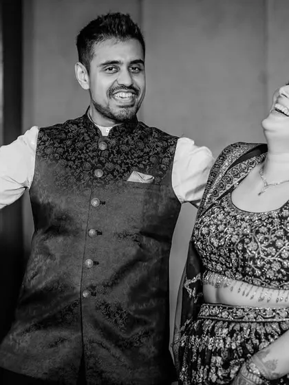 Pure, uninhibited laughter. This black and white candid shot shows the couple sharing a moment of genuine fun and connection.