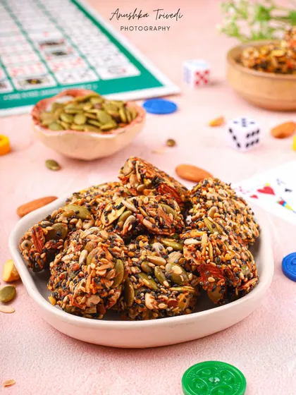 The healthy seed bars styled in a playful setting with board games, suggesting a fun snack for game night.