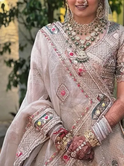 The final look. The deep color of the bridal mehendi beautifully complements the bride's stunning wedding lehenga and jewelry.