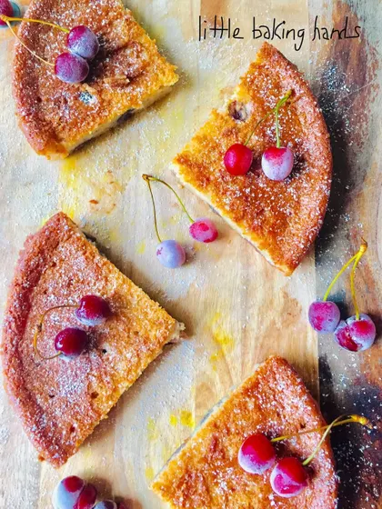Another artistic shot of the sliced vegan cake, showing the beautiful contrast between the golden cake and the bright red cherries.