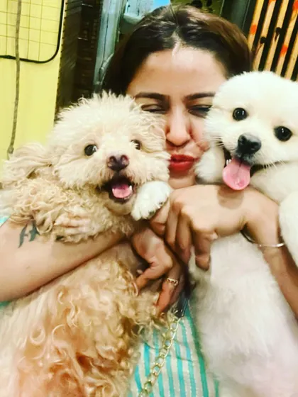 For me, it's not just a business, it's a life full of love. I get to cuddle these adorable babies all day. This is me with two of my happy guests, who are all smiles after a fun day of play.