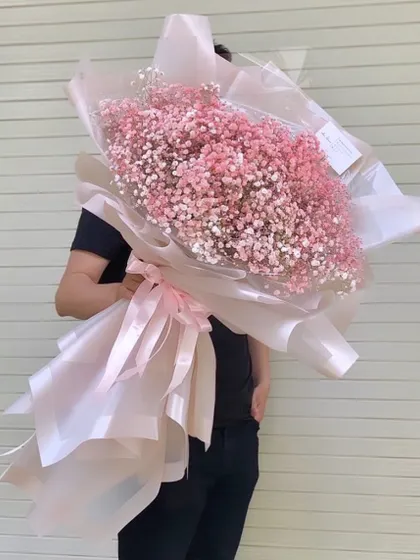 A breathtakingly large hand bouquet made entirely of pink baby's breath, also known as gypsophila. The sheer size and cloud like texture of this arrangement make it a real showstopper.