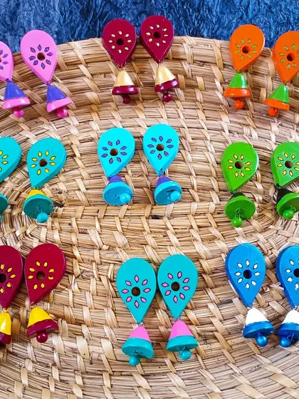 A collection of my quirky, leaf-shaped dangler earrings with tiny jhumka bells. These come in a rainbow of colors and are a fun, youthful design.
