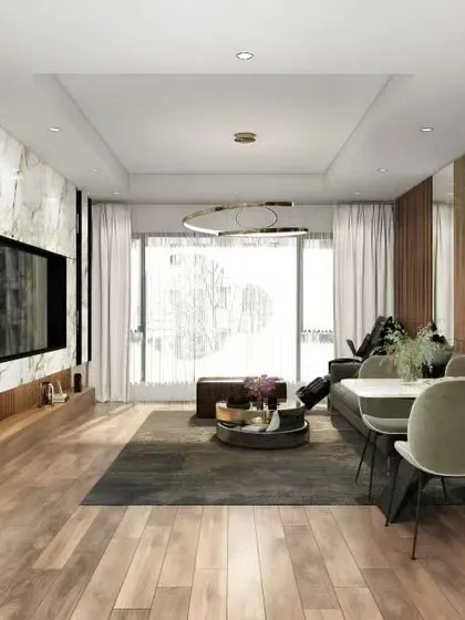 Another view of the open-plan living space, showing the flow from the dining area to the living room and balcony. The use of natural wood flooring throughout connects the different zones seamlessly.