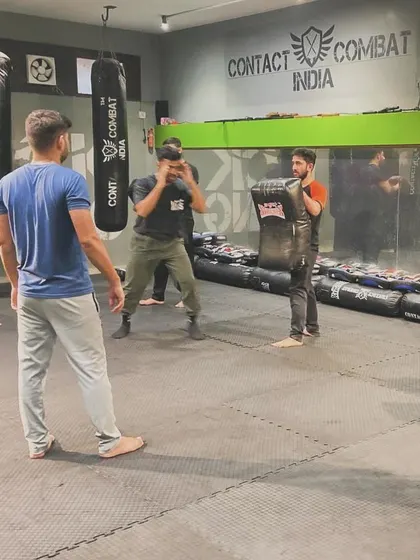 I am always supervising my students, ensuring they are using proper technique and training safely. Here, I watch over a pad work drill.