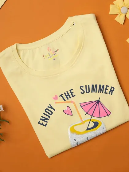 A styled flat-lay product photograph for a kids' t-shirt. This type of e-commerce photography is great for showing product details in a creative way on websites and social media.