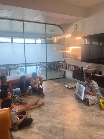 A group of young thinkers engaged in a screen-free coding activity. They are using storytelling and teamwork to understand complex concepts like sequencing in a simple, tangible way.