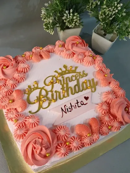 A lovely square cake with pink piping and a "Princess Birthday" topper.