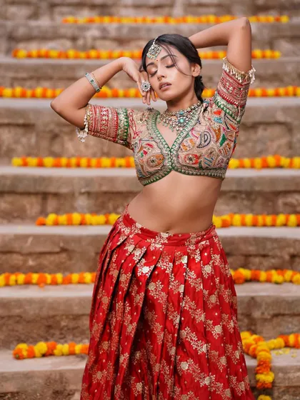 An artistic pose from the same shoot. The makeup looks flawless even in dynamic poses, highlighting its professional quality.