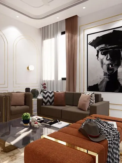 This living room design for a project in Rajasthan uses earthy tones and bold artwork to create a calm yet powerful atmosphere. The classic wall mouldings with gold trim add a touch of understated luxury.