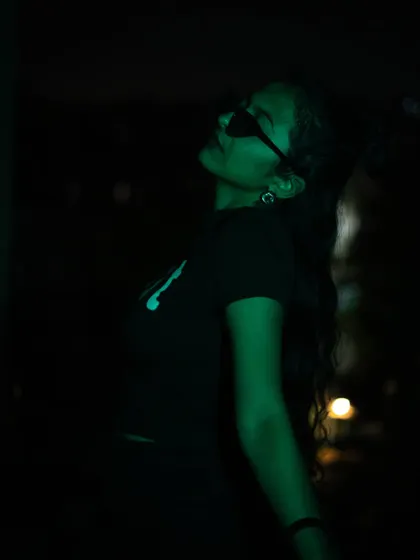 A profile shot using dramatic green lighting against a dark background. This image highlights my silhouette and creates a futuristic, edgy mood.