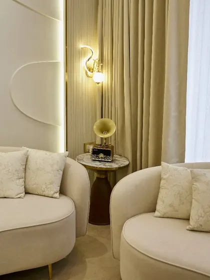 A close-up of the elegant swan-shaped wall sconce and vintage radio. These small decor pieces add a layer of personality and charm to the overall design.
