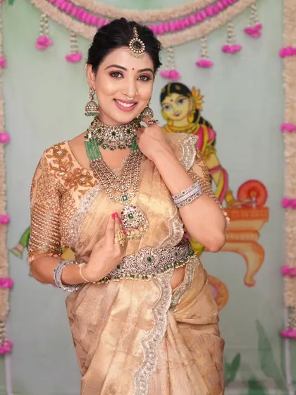 A beautiful semi-bridal look featuring a Victorian-style choker and layered necklace with green stones. The hair accessory adds a lovely finishing touch.