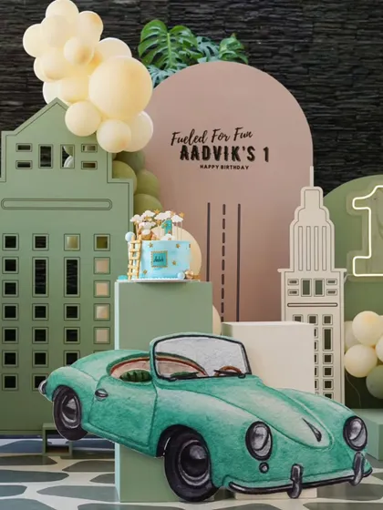 The full view of the stylish vintage car themed birthday. The muted green and beige color palette gives it a sophisticated, retro feel that's different from typical kids' party themes.