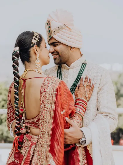 A beautiful portrait from the back, highlighting the bride's stunning hairstyle and the couple's intimate connection.