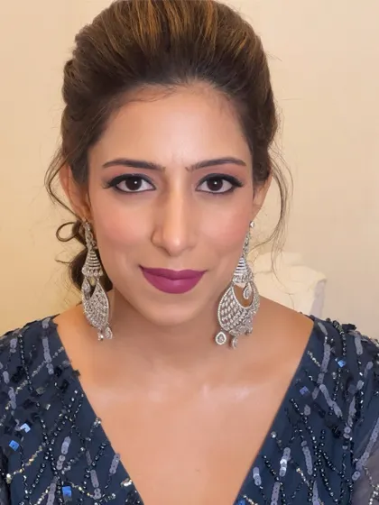 This look is all about a bold, confident statement. The dramatic eye makeup and strong lip color are perfect for a client who wants to stand out.