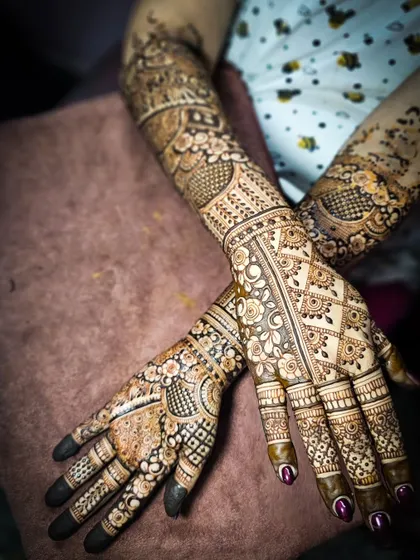 A top-down view of a complex bridal design, featuring a mix of floral, geometric, and traditional elements.