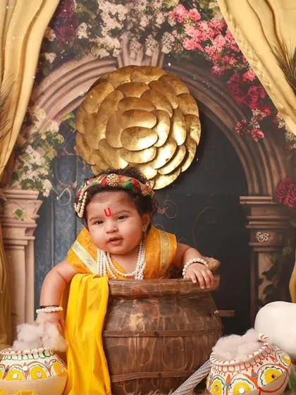 A mischievous little Krishna peeking out from his pot of butter. This is a fun and interactive shot that brings the stories of Kanha to life.
