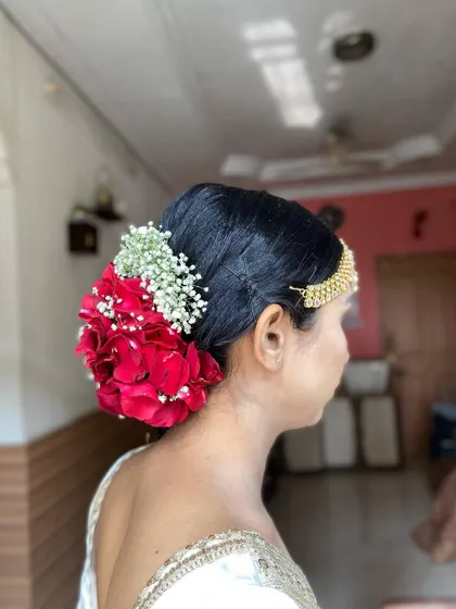 A side view of the rose bun, highlighting how it elegantly sits at the nape of the neck.