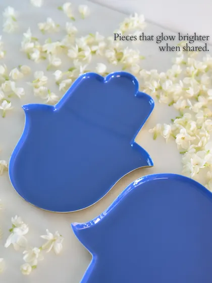 Pieces that glow brighter when shared. Our Hamsa-shaped plates in a brilliant blue are designed to bring blessings and protection to your home, making them a meaningful gift for loved ones.