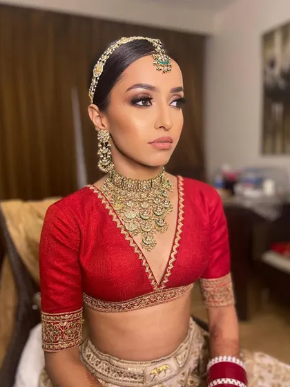 A close-up of Pawlin's sultry smokey eye for her pheras. The deep, blended tones create a dramatic effect that beautifully contrasts with her classic red blouse.