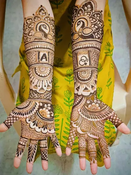 A clear view of the personalized elements in this design: the initial 'A' and the interlocking rings, surrounded by beautiful peacock art.