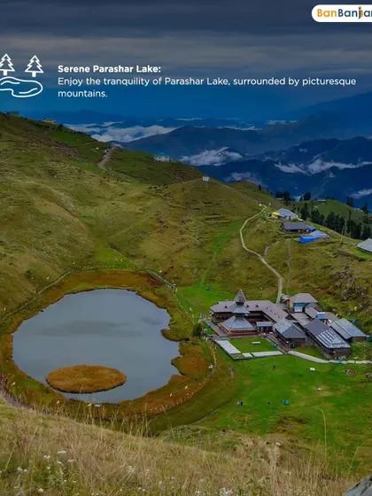 An overhead view of the serene Parashar Lake, surrounded by green hills and a clear sky. The tranquility you feel here is perfect for meditation and self-reflection.