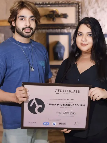 Presenting a certificate to another talented student. Her passion for makeup is clear.