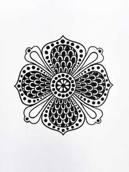 This floral motif uses repeating scallop patterns to create a sense of fullness. It's a simple yet elegant design, drawn entirely with black ink.