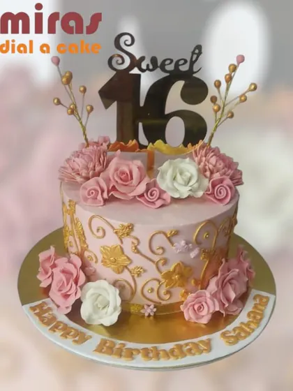 A gorgeous "Sweet 16" cake in shades of pink and gold. The cake is adorned with beautiful pink roses and delicate golden branches, creating a truly enchanting look for a milestone birthday.