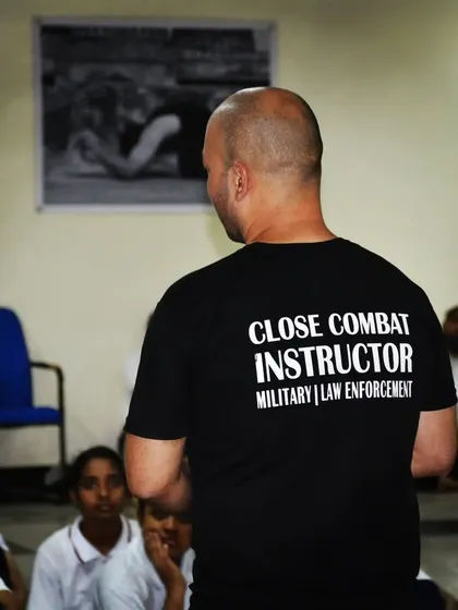 As a Close Combat Instructor for military and law enforcement, I bring the same discipline and realism to my civilian workshops. Here, I'm addressing a class of young students, instilling the values of respect and awareness.