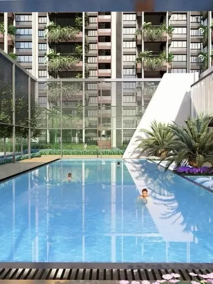 At "Villa on Sky," the swimming pool is framed by modern architectural elements and lush greenery, providing a serene retreat against the backdrop of the high-rise facade.