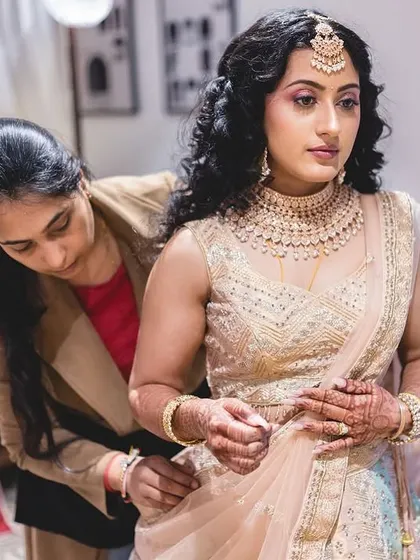 Candid shots of me in action, getting the bride ready for her big day. I take care of both makeup and final draping to ensure every detail is perfect.