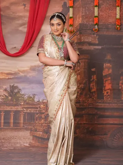 The full view of this elegant saree and blouse combination, set against a traditional backdrop.