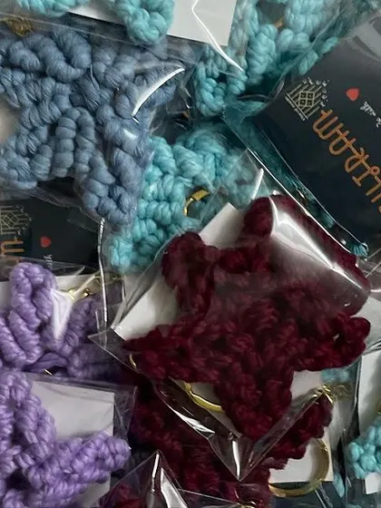 A box full of colorful star keychains, ready to be shipped out for a bulk order. I love seeing them all together like this.