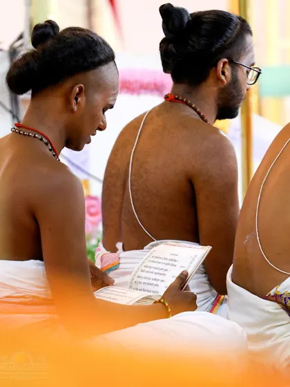 Vedic students reading from a text during the Shat Chandi Homa. The preservation and chanting of these ancient scriptures is a core part of our mission.