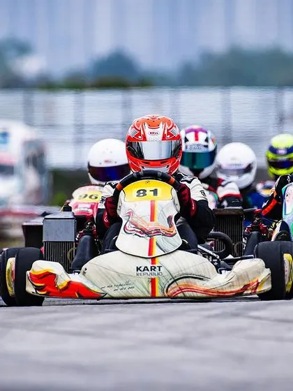 A tight formation of karts heading into the first corner.