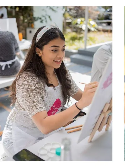 A smiling participant enjoying the painting process. My goal is to make everyone feel comfortable and confident, no matter their skill level.