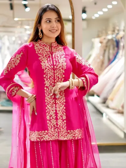 Golden threads and timeless elegance. This hot pink sharara set with gold embroidery is perfect for a festive celebration.