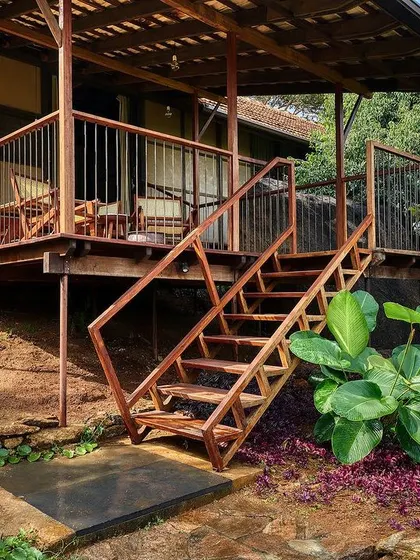 A different angle of the prefab cottage's exterior, highlighting its integration with the surrounding rocks and plants.