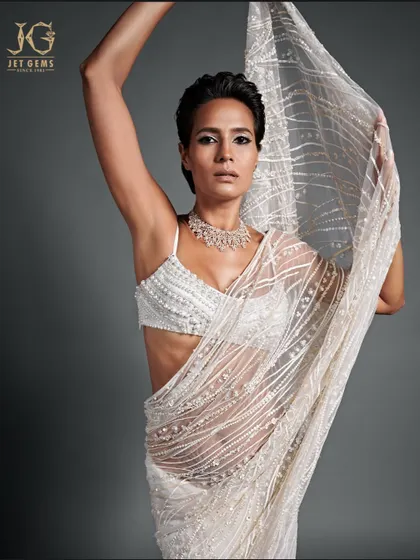 An illuminating symbol of grace. This model embodies ethereal beauty, adorned in our magnificent diamond and pearl drop necklace.